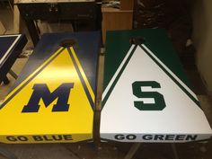 three different colored signs sitting on top of a table next to each other in a room