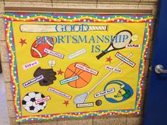 a bulletin board with sports related items on it in a school hallway or classroom room