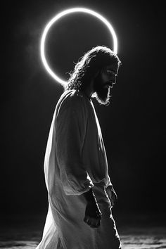 a man with long hair and beard standing in front of a circle of light above his head