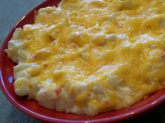 a red plate topped with macaroni and cheese