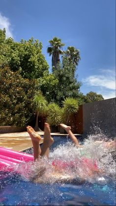 two people are playing in an inflatable pool