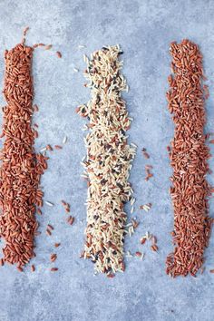 three different types of rice on a blue surface