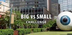 an eyeball with the words big vs small challenge in front of buildings and trees