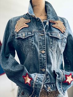 a denim jacket with red and white stars on the back, worn by a woman