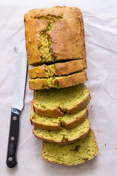 sliced loaf of zucchini bread next to a knife