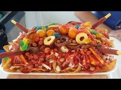 a very large pile of food sitting on top of a white plate filled with lots of toppings