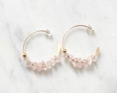 Beautiful Natural Rose Quartz in 18k gold filled half open hoops with rubber backing. So Gorgeous, subtle, feminine, and soft. 💕Rose quartz is the stone of love and romance. Draw in romance with this simple yet elegant, soft, dainty design adds a subtle beauty to your outfit and brings out your skin tone with a sense of femininity with its simplistic elegance. Simple, Dainty, Delicate, yet so Elegant and Romantic. The shine and color are so gorgeous. The picture does not do its justice the piec Delicate Rose Gold Pierced Hoop Earrings, Delicate 14k Gold Filled Hoop Earrings, Delicate 14k Gold Filled Hoop Jewelry, Delicate Small Hoop Pierced Earrings, Delicate Hoop Jewelry As Gift, Delicate Hoop Jewelry For Gift, Dainty Pink Hoop Jewelry, Wire Wrapped Rose Gold Hoop Jewelry, Delicate Hoop Huggie Earrings As Gift