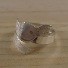 A cute and unusual ring perfect for axolotl lovers. The shape of an axolotl head has been hand pierced from a sheet of 100% recycled sterling silver. The details of the face have been hand drawn and etched and the fronds have been engraved to give them texture. A long strip with an axolotl tail has then been hand pierced and soldered to the head. The strip has then been bent around a mandrel to form the ring and oxidised to blacken the etched details. Approx UK Ring Size 'S' but it is adjustable Hand Piercing, Unusual Rings, Bagan, Recycled Sterling Silver, Band Rings, The Face, Hand Drawn, Jewelry Rings, How To Draw Hands