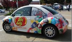 a car that has been painted to look like it is advertising jelly beanies on the side