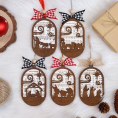 christmas ornaments are arranged on a white furnishing with red and black bows, including an ornament