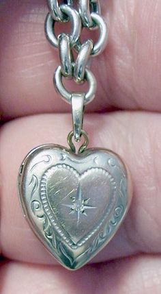 ~ Vintage 14K white gold heart locket on a 14K white gold bracelet - locket measures almost .5" tall and .5" wide at the widest point - it has a moissanite center stone inside a star and a lovely scroll design - inside are two sides for tiny photos - it closes securely. ~ Looking closely, it is etched with names on the reverse that have faded with time - it reads "Kelci and Dougie" - could possibly be buffed out - it is also hallmarked "14K" and "Tk" - the "T" and the "k" are conjoined and are t Mermaid Artwork, Gold Heart Locket, White Gold Bracelet, Scroll Design, Heart Locket, Locket Necklace, Gold Heart, Heart Of Gold, Christmas List