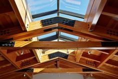 the inside of a wooden building with skylights