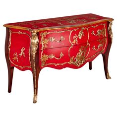 an ornate red and gold painted chest