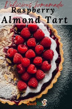 raspberry almond tart on a plate with powdered sugar and fresh raspberries