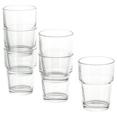 four clear glass cups sitting next to each other