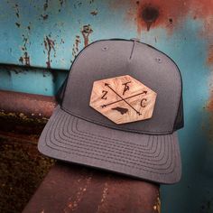 This customized hat is great for every Lineman who works hard to keep our power on. The leather patch in front will come with your Initials on either side of the cross arrows and your state on the bottom. The Lineman will sit on top. If you are looking for a different emblem please let us know and we will see if we can find it. This is a one size fits most, adjustable snap back Richardson original 112 trucker hat in gray and black. We can use any country/state on these hats. If you need one not Trucker Hat With Leather Patch, Six-panel, Custom Outdoor Hat With Flat Bill, Custom Outdoor Baseball Cap With Flat Bill, Custom Flat Bill Hat For Outdoor, Custom Adjustable 5-panel Hat, Leather Patch Trucker Hat 5-panel, Custom Flat Brim Trucker Hat For Outdoor, Custom Outdoor Snapback Hat, Custom Flat Brim Snapback Hat For Outdoor