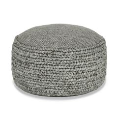 a grey round poufce with braiding on the top and bottom, sitting in front of a white background