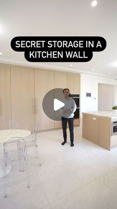 a man standing in the middle of a kitchen