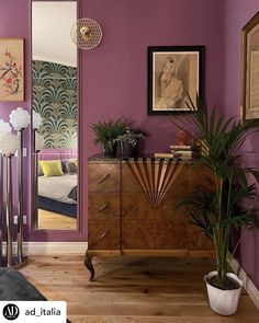 a living room with purple walls and wooden floors