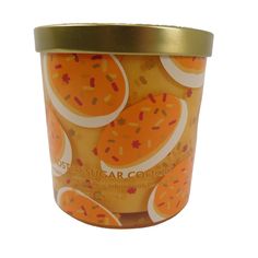 an ice cream cup with oranges and sprinkles on the inside, in front of a white background