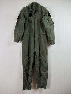 "Vintage 1970s green poly/cotton jumpsuit, flight suit, coveralls. Has many zippered pockets and velcro cuffs. U.S. Air Force issue. No labels. About a size medium. Actual measurements are: 42\" at the chest 40\" at the waist(can adjust smaller) 20\" shoulder seam to shoulder seam 23\" shoulder seam to cuff 27.5\" inseam In good condition with a couple of spots(photo) and a stitched repair at lower leg(photo)." Leg Photo, 1970s Jumpsuit, Vintage Coveralls, Jumpsuit Vintage, Suit Vintage, Vintage Jumpsuit, Flight Suit, Cotton Jumpsuit, U S Air Force