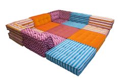 a multicolored patchwork couch sitting on top of a white floor