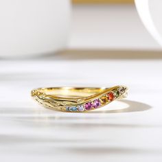 A colorful kaleidoscope of stones! This is a gorgeous vintage multi-colored Band Ring, set in ornate sterling silver. The glamorous stones glimmers in the light revealing a rainbow of colours.  An twist shank with carved design completes the retro look. Remember all your beautiful yes moments with this band.Carat Weight: 0.364 ctStone Size: 1,1.6,1.2,1.6,1.0,1.8,1.7,1.4,1.2,1.7 mmStone Type: Jeulia® StoneNumber of Stones: 10 Stone Color: Diamond White, Peridot Green, Aquamarine Blue, Fuchsia, Citrine Yellow, Amethyst Purple, Emerald Green, OrangeStone Shape: RoundWeight: 2.63 gMaterial: 925 SilverPlating Color: Yellow Gold Green Aquamarine, Peridot Green, Amethyst Purple, Aquamarine Blue, Multi Stone, Band Ring, Diamond White, Ring Set, Emerald Green