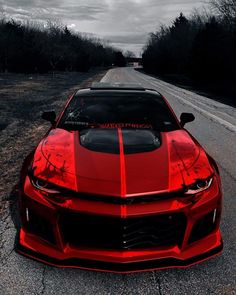 a red sports car parked on the side of a road