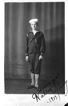 an old black and white photo of a young man in sailor's uniform with his hands on his hips