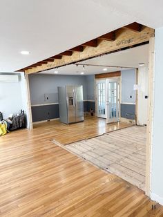 an empty room with hard wood flooring and walls in the process of remodeling