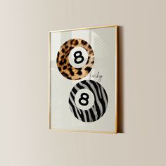 an animal print hangs on the wall next to a pair of eyeglasses that read 8 and eight