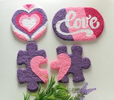 two pink and purple magnets with the word love on them