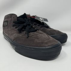 This rare pair of Vans Half Cab sneakers in a dark brown and black colorway is a must-have for any sneakerhead. The shoes are unisex and come in size 12 for UK shoe sizes, with various sizes available for US and EU shoe sizes. These sneakers feature a low-top shoe shaft style with a lace-up closure, and come in standard shoe width. The Vans Half Cab model is a classic athletic shoe style that is perfect for skateboarding, casual wear, or any other activity. The shoes are brand new and come without a box. Get your hands on these unique sneakers before they're gone! Vans Black Shoes, Black Low-top Thick Bottom Skate Shoes, Comfortable Black Low-top Skate Shoes, Black Low-top Skate Shoes With Rubber Toe Cap, Functional Black Low-top Skate Shoes, Black Synthetic Vans Skate Shoes, Vans Skate, Black Shoes Men, Unique Sneakers