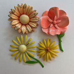 Lot of three in preowned vintage condition with some small chips/cracks to paint.  Largest measures approximately 3" tall Luxury Enamel Flower Brooches, Vintage Pink Collectible Brooches, Retro Flower Brooches For Collectors, Vintage Yellow Flower Brooch, Vintage Enamel Flower Brooch, Daisy Vintage, 70s Mod, Mid Century Jewelry, Pink Daisy