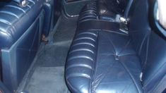 the interior of a car with blue leather seats and black dash tape on the floor