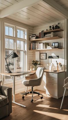 a home office with desk, chair and bookshelf in front of large windows