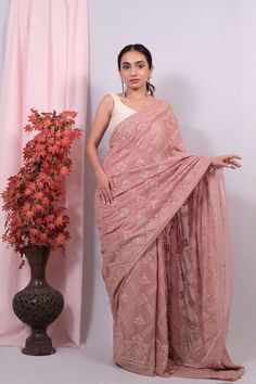 Dusty Peach Lakhnavi Chikankari Saree For Women | Wedding wear | Traditional Wear Lakhnavi Georgette sarees are a beautiful manifestation of the rich cultural heritage of Lucknow, India. These sarees are crafted with intricate Chikankari embroidery, a traditional Lucknawi hand embroidery technique. Georgette, a lightweight, sheer fabric, adds a graceful flow to the saree, making it perfect for both casual and formal occasions. The Chikankari work on these sarees often features delicate floral motifs, paisleys, vines, and other intricate designs, all meticulously hand-embroidered by skilled artisans. The embroidery is usually done with white thread on pastel-colored georgette fabric, creating an elegant and timeless appeal. Lakhnavi Georgette sarees are cherished for their exquisite craftsm Luxury Pink Chikankari Embroidery Saree, Pre-draped Saree With Chikankari Embroidery For Navratri Reception, Pre-draped Saree With Chikankari For Navratri Reception, Navratri Reception Pre-draped Saree With Chikankari Embroidery, Pre-draped Saree With Chikankari Embroidery For Reception, Pre-draped Saree With Chikankari Embroidery For Transitional Reception, Festive Designer Pre-draped Saree With Chikankari Embroidery, Pink Pre-draped Saree With Motifs, Designer Chanderi Pre-draped Saree With Chikankari Embroidery