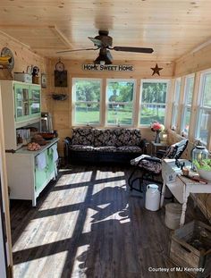 the sun shines through the windows in this small room with wood flooring and furniture