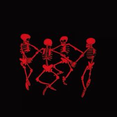 three red skeletons dancing in the dark