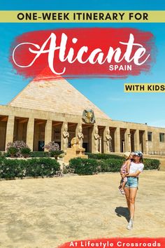 a woman walking in front of a building with the words alcante spain on it