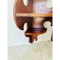 a wooden shelf with two holes in it