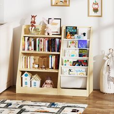 a bookshelf filled with lots of books on top of a hard wood floor