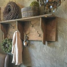 a living room filled with lots of furniture and decor on top of wooden shelves next to a wall