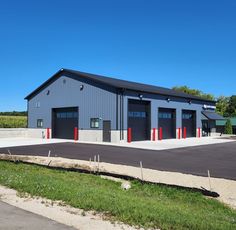 an industrial building with two garages and three doors