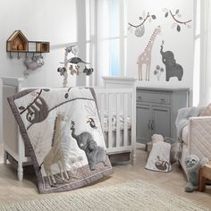 a baby crib bedding set with animals and giraffes on it