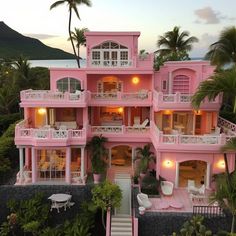 an aerial view of a pink house with white balconies