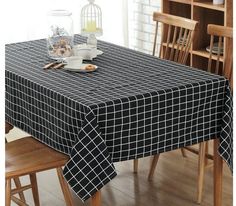 a dining room table covered with a black and white checkered tablecloth