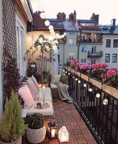 a balcony with lots of plants and lights