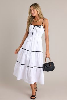 Discover a delightful surprise with our White Tiered Midi Dress. Each tier adds a playful twist to your outfit, while the midi length flatters your figure. Perfect for any occasion, this dress will have you turning heads with its unique style. This white midi dress features a square neckline, thin adjustable straps, a self-tie bust feature, an elastic waist, contrasting tiers, and a flowing silhouette.  97% Cotton, 3% Spandex Lined 100% Polyester Hand Wash Cold Manufactured in China Designed in the USA Model is wearing a size small Summer Long Dress, Long Dress For Women, Sorority Rush Dresses, Dress Fancy, Rush Dresses, Clothing Factory, Cotton Dress Summer, White Midi, Tiered Midi Dress