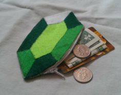 a coin purse with money in it sitting on top of a white sheet